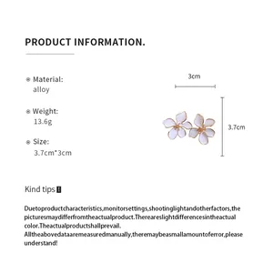 Detailed macro view showing dimensions and specifications of white flower drop earrings