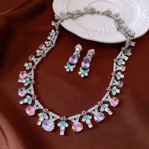 Exquisite vintage jewelry set with colorful zircons and green enamel on brown satin