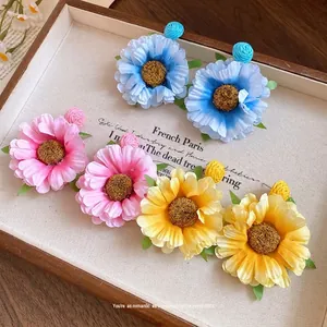 Elegant fabric flower drop earrings with raffia details and silver needle studs