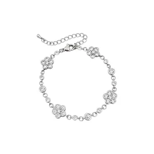Elegant silver camellia flower bracelet with sparkling zircons on a white background.
