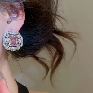 Elegant close-up showing detail of luxury pink square zircon earring with floral border