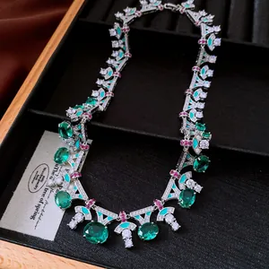 Detailed view of a vintage emerald green zircon necklace in a luxury display box