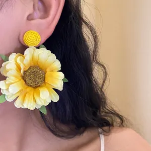 Elegant handmade yellow raffia flower drop earrings featuring silver needle posts for women