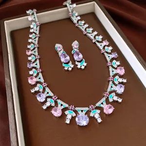 Detailed view of vintage zircon necklace and earrings set with pink and lavender stones