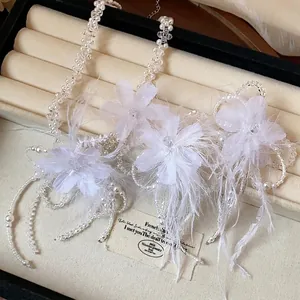 Elegant white feather flower and pearl jewelry set including necklace and accessories