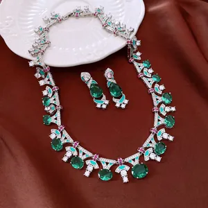 Elegant close-up of a vintage jewelry set featuring green oval zircons and silver details