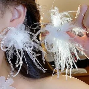 Elegant white feather flower and pearl earring set for a sophisticated bridal look