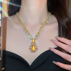Luxurious yellow square zircon necklace detail with sparkling effects on a model neck