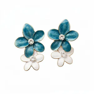 Elegant blue and white flower drop earrings with crystal accents on a white background