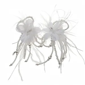 Elegant white feather and pearl jewelry set featuring delicate mesh flowers for weddings