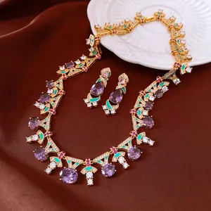 Detailed view of vintage gold necklace and earrings set with purple gems and teal enamel