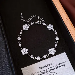 Close-up of silver-plated camellia flower bracelet with sparkling zircons