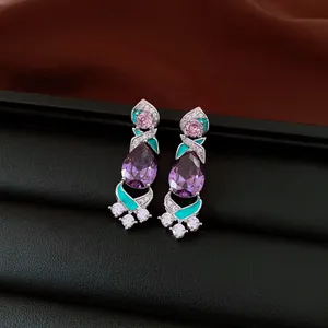 Detailed view of vintage zircon teardrop earrings with purple and turquoise accents