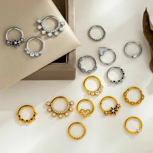 Collection of stainless steel septum rings with heart and flower designs in gold and silver