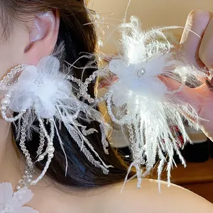 Close-up detail of elegant white feather flower necklace with delicate pearl beads for women