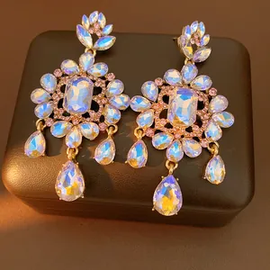 Close-up detail of ornate teardrop flower earrings with shimmering crystals