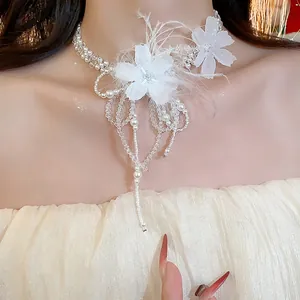 Close-up of elegant white feather flower pearl necklace with cascading crystal bead fringe