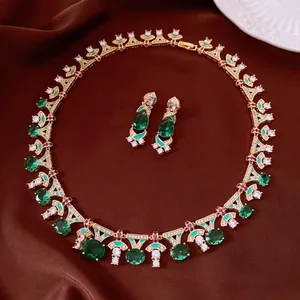 Exquisite vintage gold-tone jewelry set featuring oval green emerald-style zirconia stones.