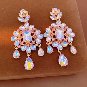 Macro view of vintage-style floral drop earrings with AB crystals and gold setting