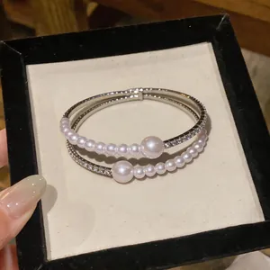 Close-up of elegant double-strand bracelet with pearls and rhinestones in display box