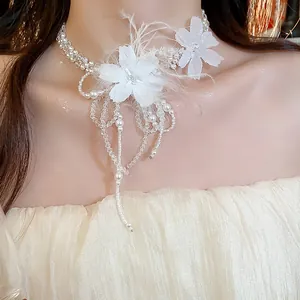 Elegant macro view of white feather and flower pearl necklace with intricate beadwork