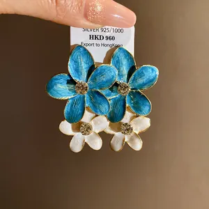 Elegant blue and white enamel flower drop earrings with crystal centers on tag