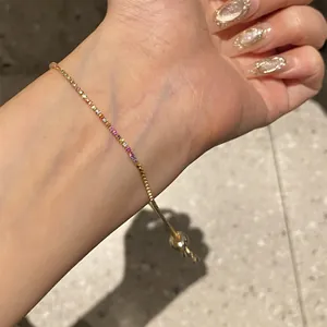 Detailed view of 18k gold-plated hand jewelry with vibrant multi-color zircon stones
