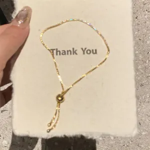 Detail view of a 18k gold plated adjustable chain bracelet with sparkling cubic zirconia stones