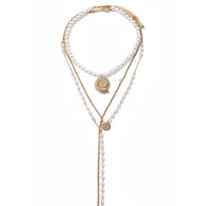 Layered pearl necklace set featuring a golden shell pendant for Bohemian vacation styles