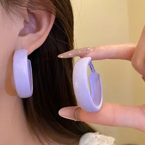 Purple spray-painted circular hoop earrings with elegant silver needle design