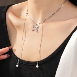 Detailed view of elegant silver butterfly pendant necklace with hanging pearl tassels