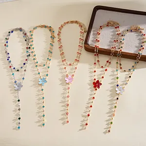 Close-up of five colorful resin flower necklaces with sparkling rhinestone accents