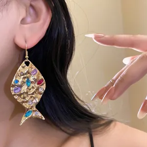 Vintage gold fish earrings with colorful rhinestones and textured surface for women.