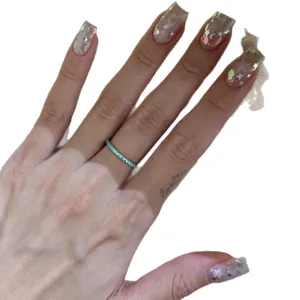 Delicate light luxury ice blue zircon thin pave eternity ring shown on model's hand