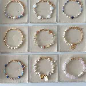 Grid display of various freshwater pearl and gemstone bracelets with French vintage charms.