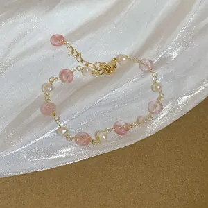 Detail view of handmade freshwater pearl and pink strawberry quartz beaded gold bracelet