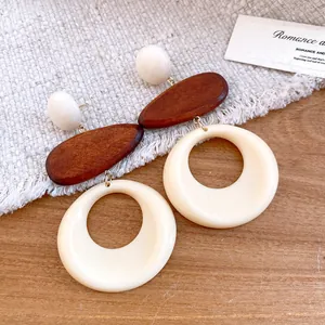 Macro view of retro resin and wood hoop earrings showing grain and smooth finish