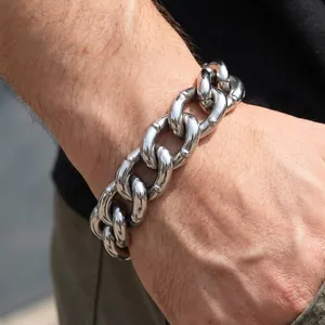 Close-up of 18mm heavy stainless steel Cuban bracelet with rivet details on man's wrist