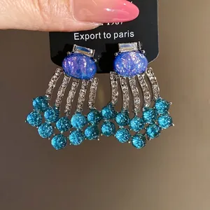 Vintage style resin tassel earrings featuring blue oval stones and shimmering rhinestones