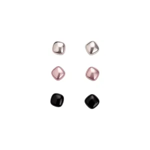 Set of three pairs of minimalist rounded square stud earrings in multi-color metallic finish.