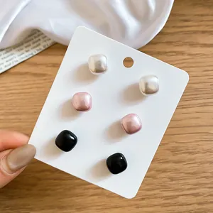 Detailed view of six French retro square pearl stud earrings in three elegant colors