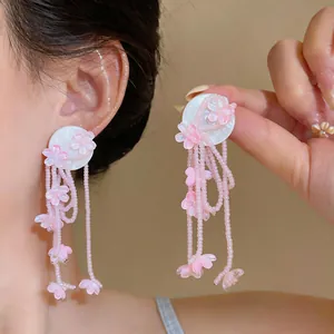 Detailed view showing the intricate pink beaded flower tassels of these sweet earrings