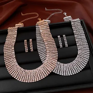 Close-up of sparkling rhinestone fringe necklace and earring sets on a display tray
