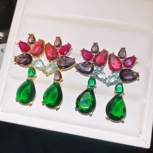 Detail of luxury colorful zircon drop earrings with vibrant green and red stones