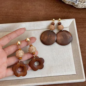 Detailed macro view of vintage ethnic wood dangle earrings with woven bead accents