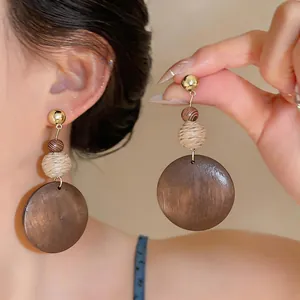 Vintage ethnic style wood round pendant earrings with woven ball detail and gold studs