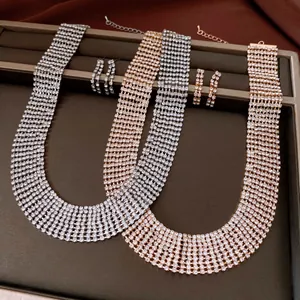 Detail view of silver and rose gold rhinestone tassel choker necklace and earrings set