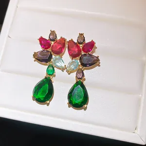 Detailed macro view of luxury colorful zircon teardrop drop earrings in a white jewelry box