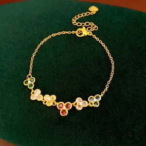 Gold-plated colorful cubic zirconia flower charm bracelet for women with green velvet backdrop
