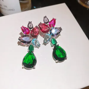 Macro detail of luxury colorful teardrop zircon earrings with vibrant faceted stones